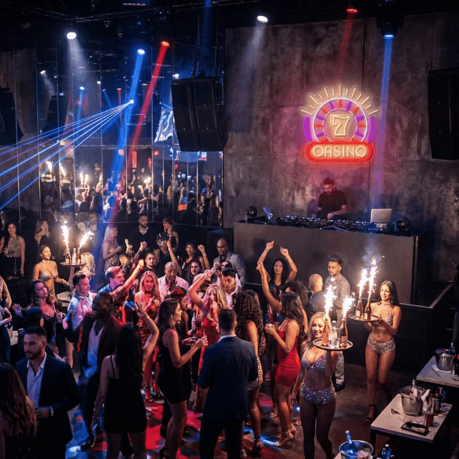 People dance and hold sparklers in a crowded nightclub, a DJ performs on stage, and the Neon CASINO sign glows in the background.