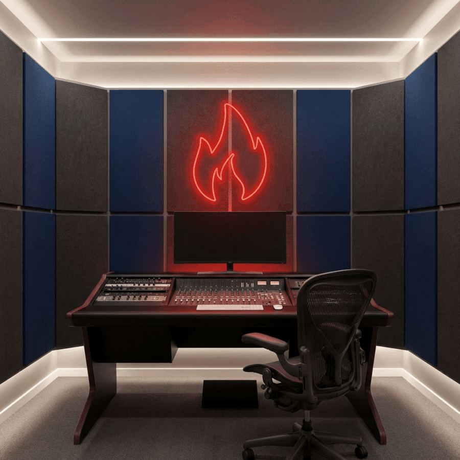A modern music studio with a mixing console, office chair, and the Neon Fire red neon sign on the wall, surrounded by blue and gray acoustic panels.