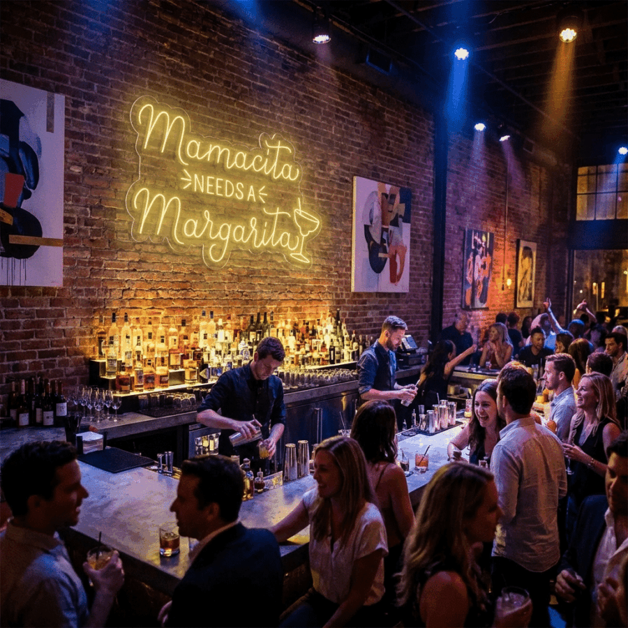 A bustling bar with bartenders serving drinks, patrons chatting, and a neon "Mamasita Needs a Margarita" sign—perfect for selfies—glowing on the brick wall.
