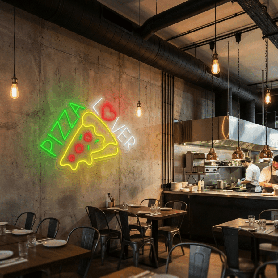 Modern pizzeria interior featuring industrial decor, set tables, chefs in an open kitchen, and a Neon Pizza Lover sign glowing on the wall.